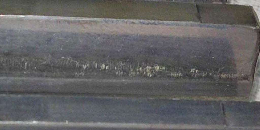 Macropitting on the tooth surface. Numerous dents on the tooth surface.