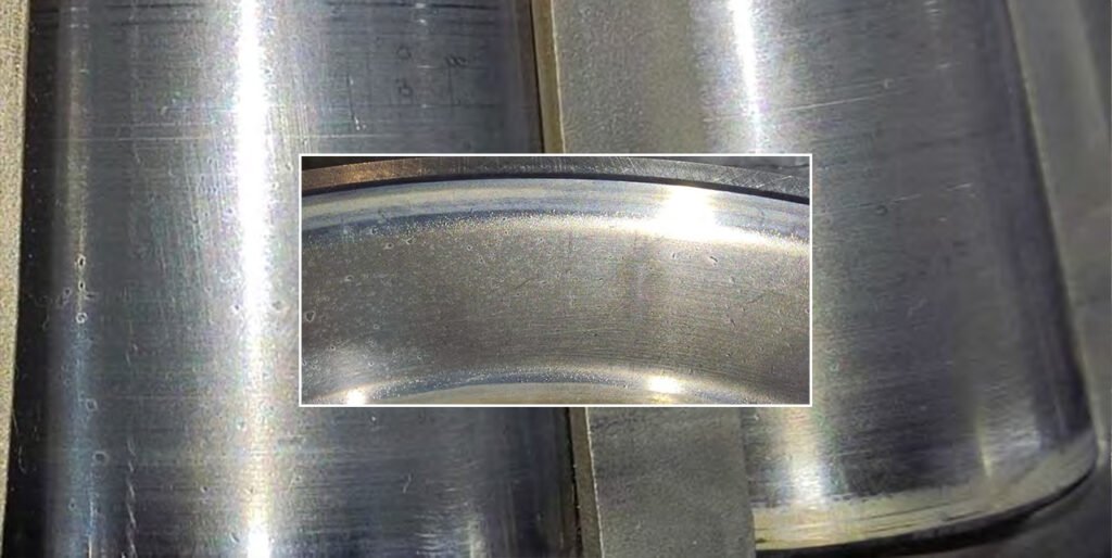 Marks on the outer race from excessive axial pressure on the bevel shaft housing cover. Chipping of the roller and outer race surfaces. Numerous dents on the roller and race surfaces.