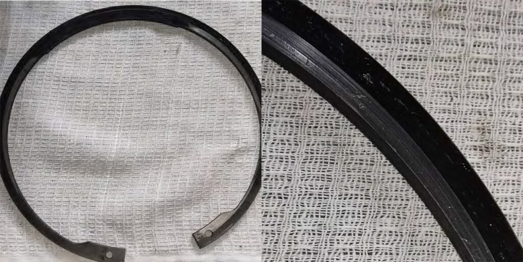 Peeling of the roller and inner race surfaces. Numerous dents on the roller and race surfaces. Traces of the bearing rotating in the housing. Traces of the outer race sticking in the housing. Retaining ring wear due to bearing rotation in the housing.