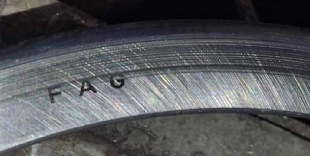 Peeling of roller and outer race surfaces. Numerous dents on roller and race surfaces. Brinelling. Traces of bearing rotation in the housing.